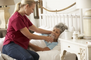 caregiver helping senior drink water